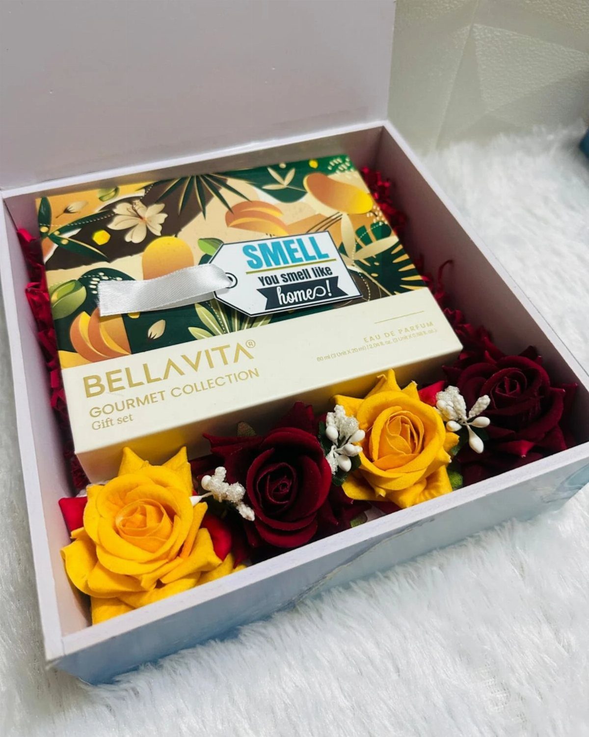 Perfume gift set with red and yellow roses in a white box