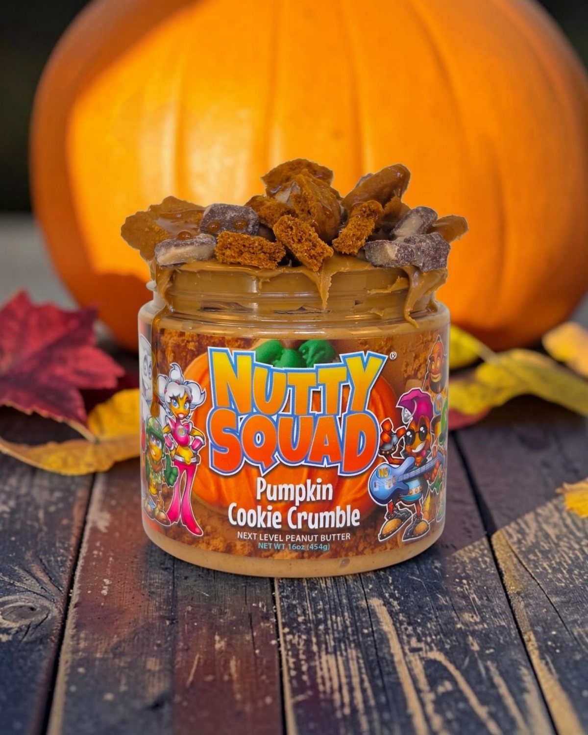 Pumpkin Cookie Crumble peanut butter jar topped with cookies beside a large pumpkin.