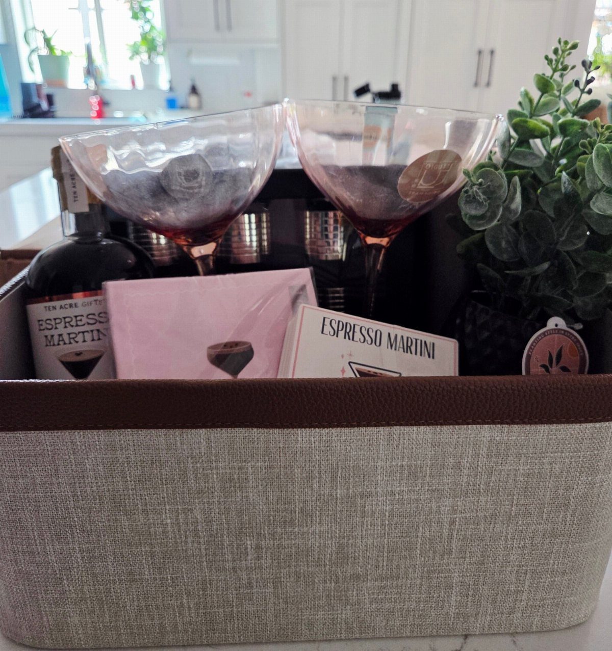 Espresso martini gift set with two glasses and a bottle in a basket.