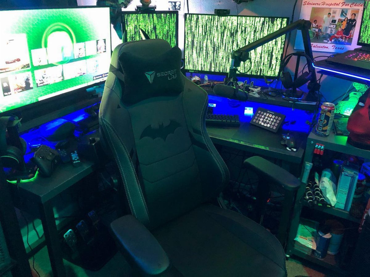 Black gaming chair with Batman logo in a room with blue LED lighting
