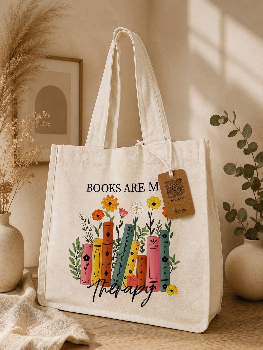 Canvas tote bag with colorful book illustration and text 'BOOKS ARE MY therapy'