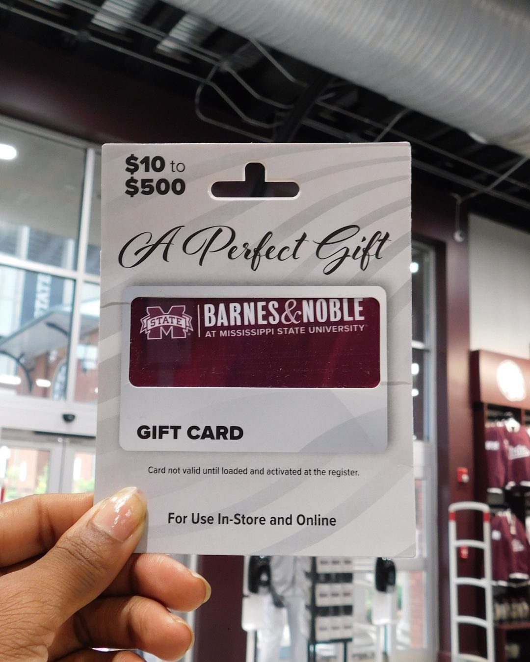 Barnes and Noble gift card in white packaging held by a person's hand.