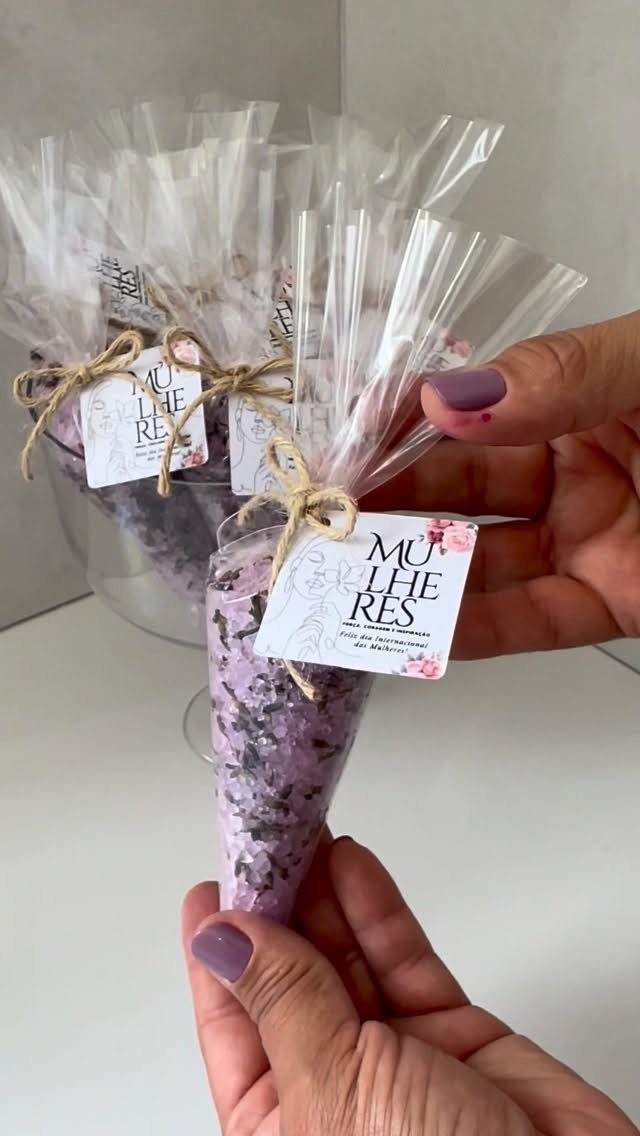 Purple bath salts in clear plastic cones tied with twine and gift tags.