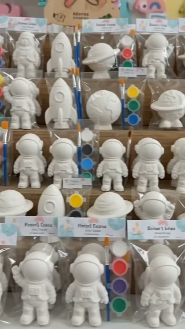 White plaster astronaut and space figurines in kits with paint and brushes.