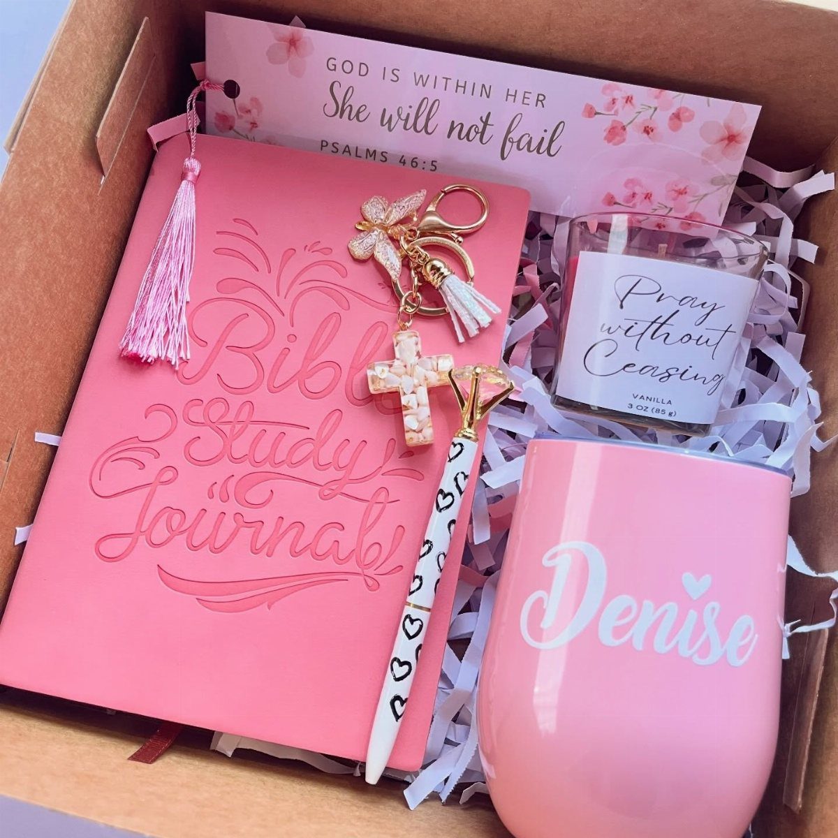 Pink Christian gift box with Bible study journal, cross keychain, and personalized tumbler.