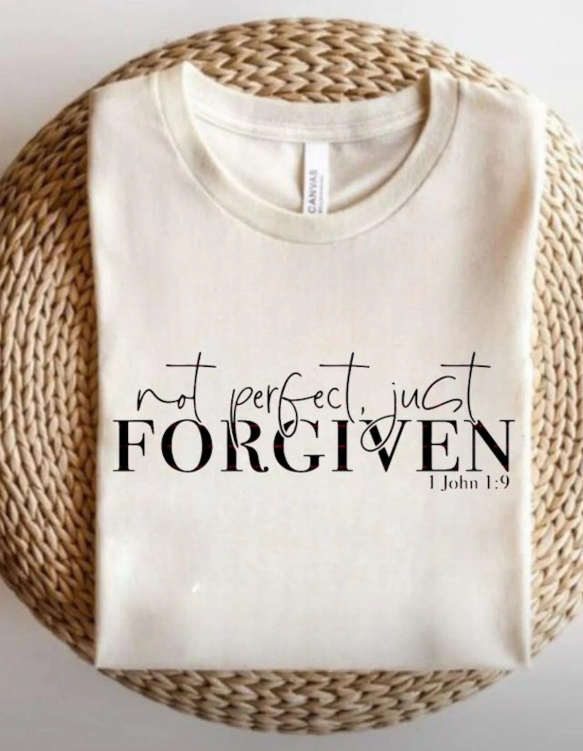 Cream t-shirt with black faith message and scripture on a woven mat