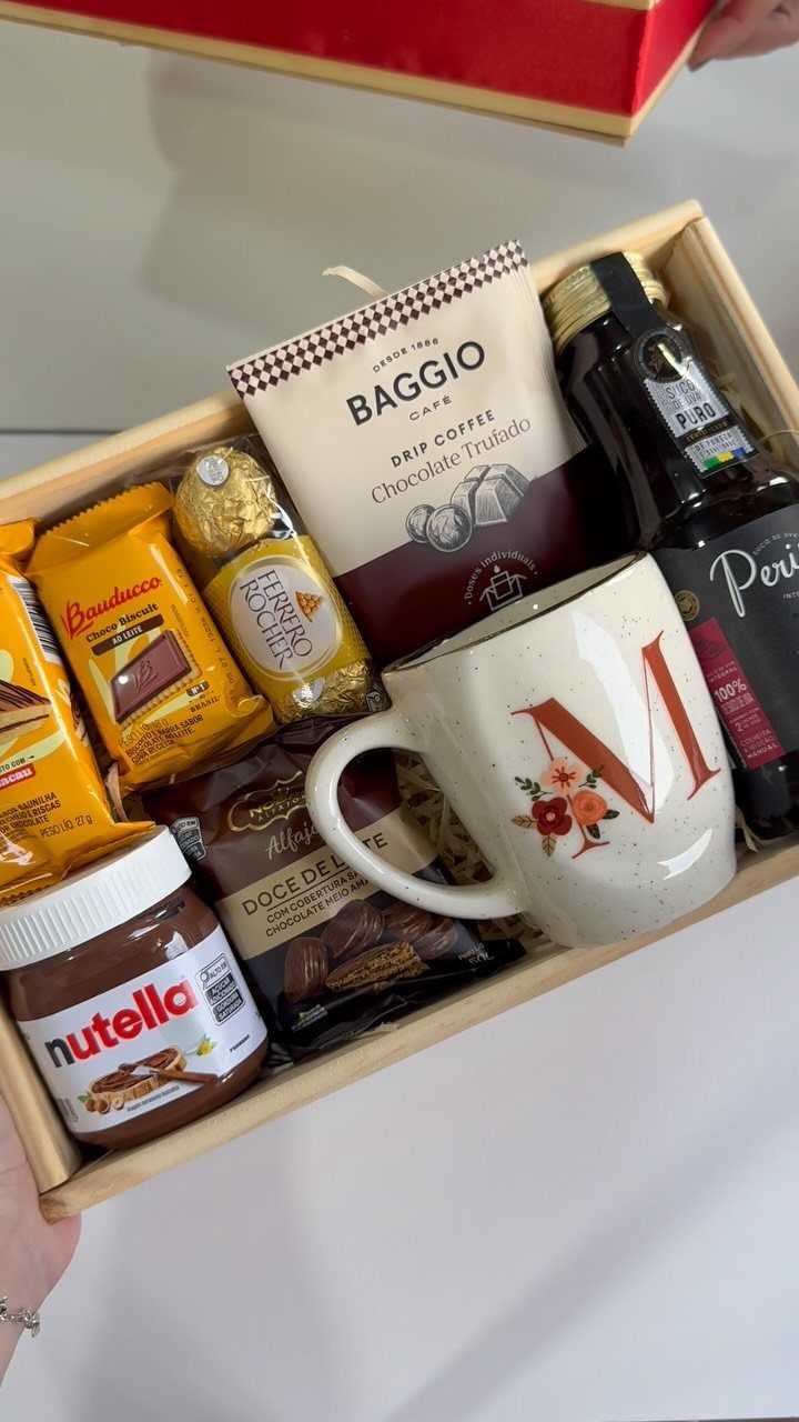Wooden gift box with Nutella, drip coffee, a decorated mug, and chocolates.