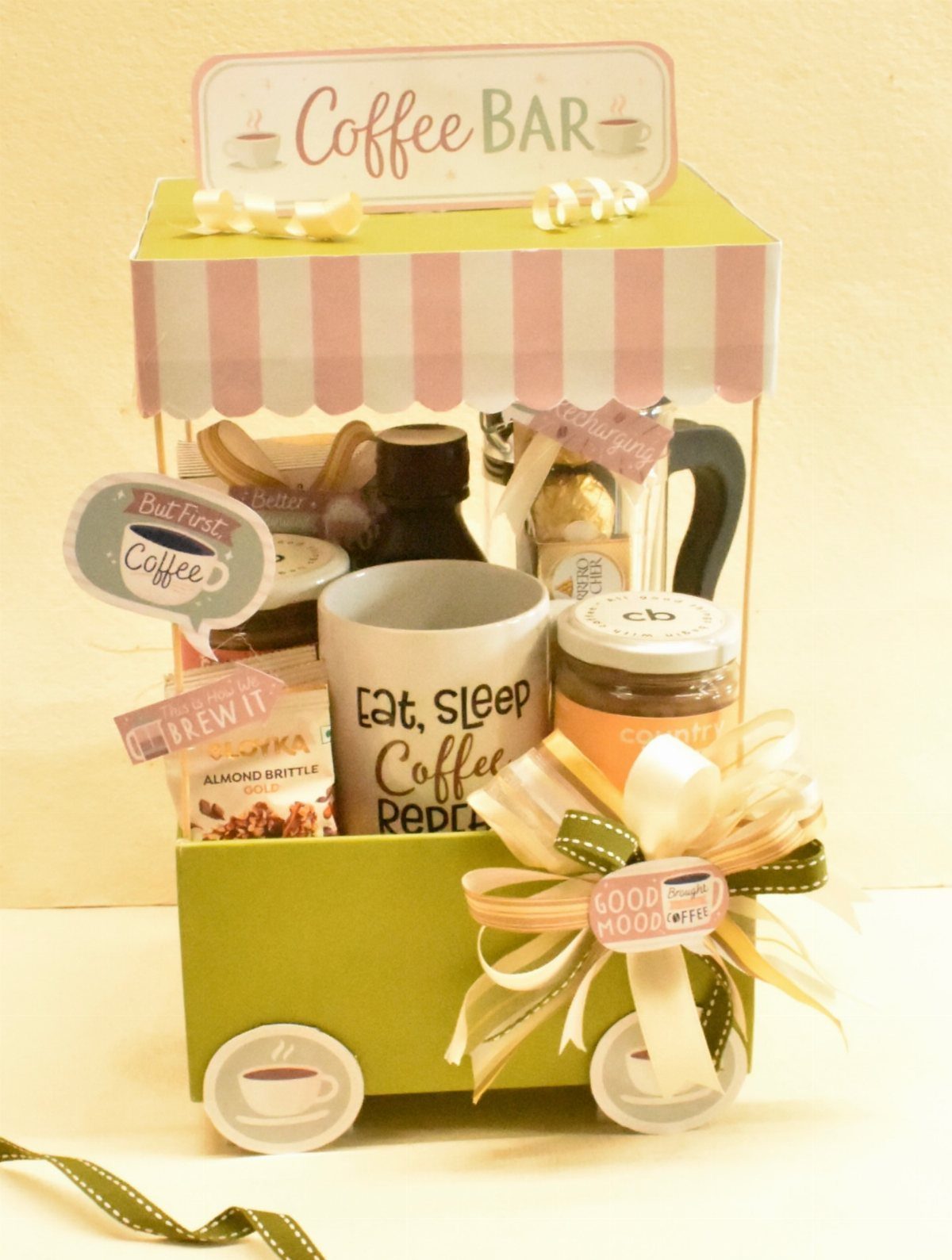 Coffee gift basket styled as a miniature cart with a mug and treats.