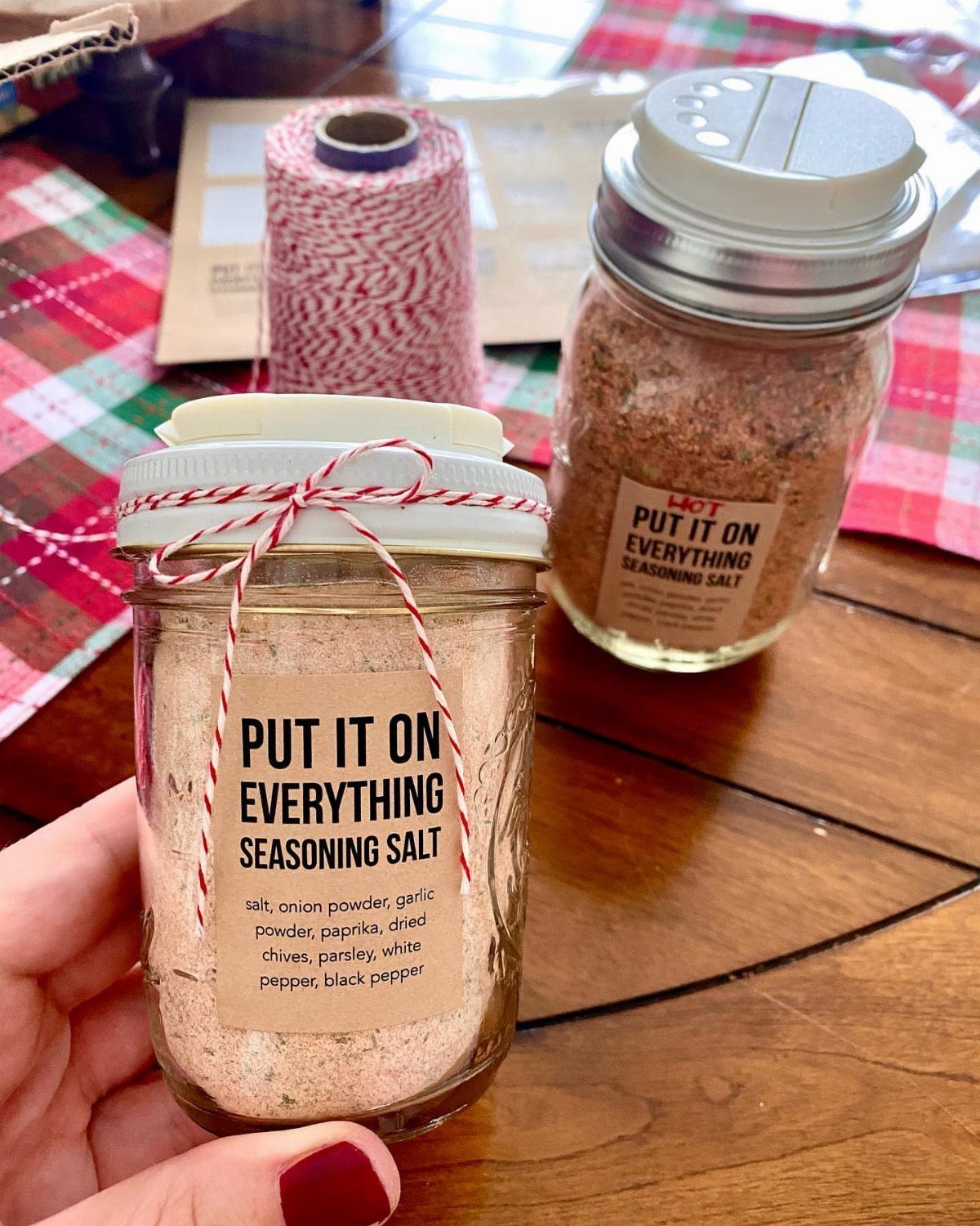 Glass jar of homemade seasoning salt with a red and white twine bow.