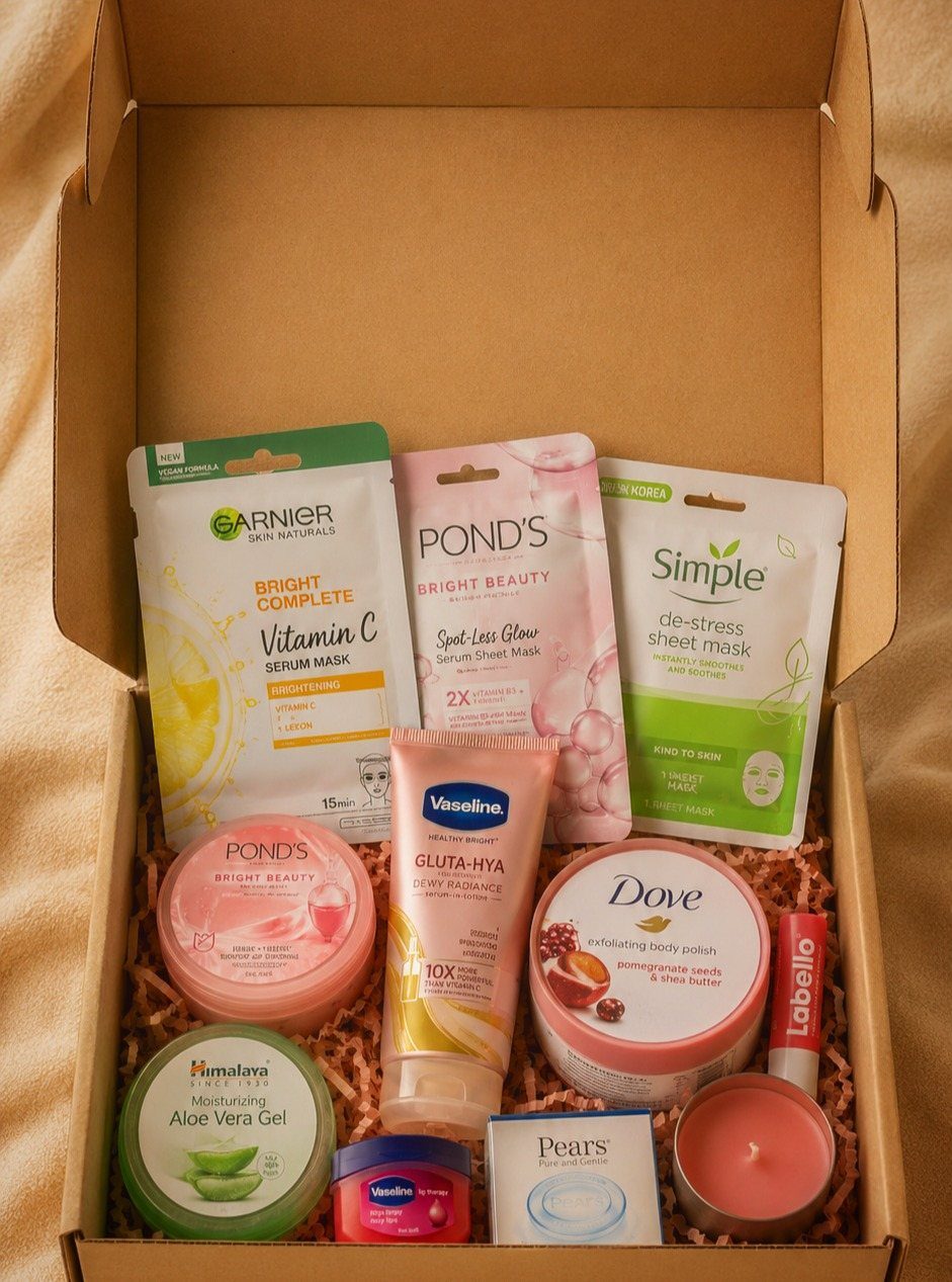 Skincare gift set in a cardboard box with masks, creams, and a candle.