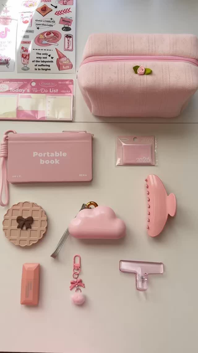 Assorted pink cozy gifts and accessories arranged on a plain white background.