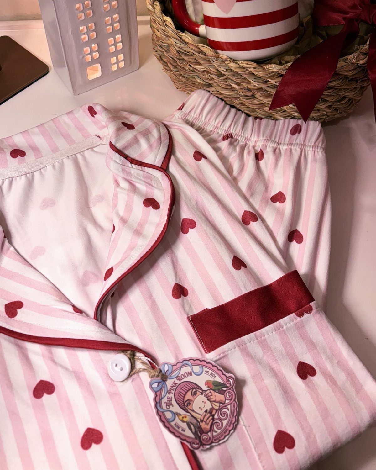 Pink and white striped pajama set with red hearts and a matching mug.