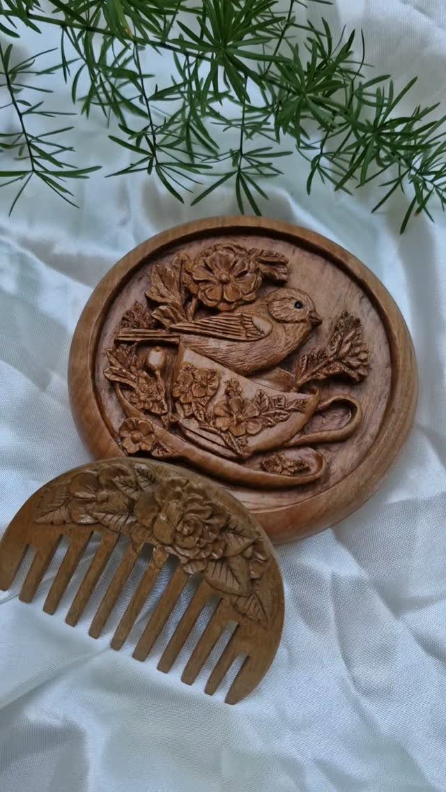Carved wooden hair comb and matching case with a bird and teacup design.