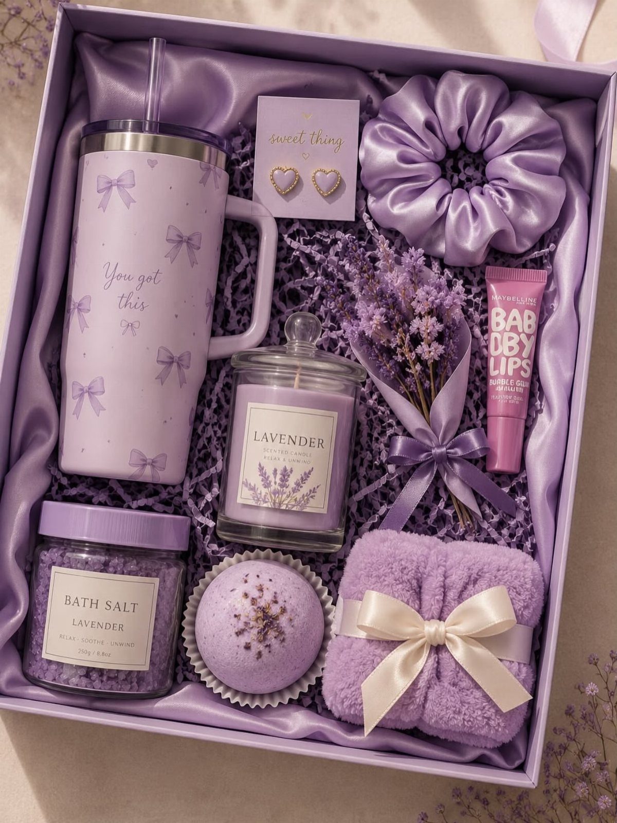 Lavender themed spa gift box with purple tumbler, candle, bath salts, and accessories.