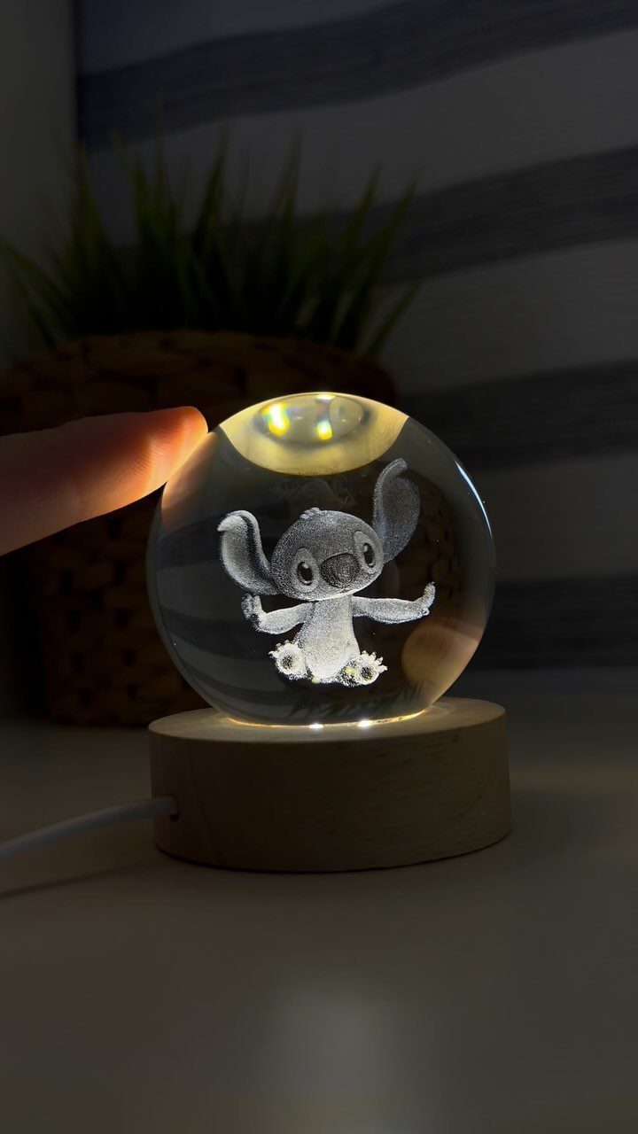 Spherical glass lamp with 3D etched Stitch figure on a wooden base