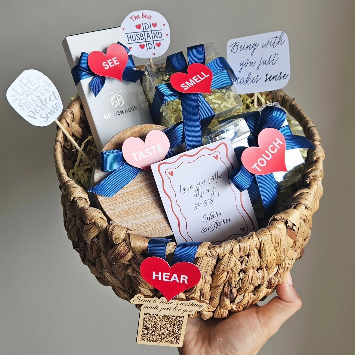 Woven gift basket with five senses heart tags and blue ribbons for a husband.