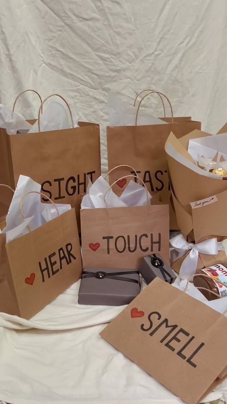 Brown paper gift bags labeled with the five senses for a themed gift set.