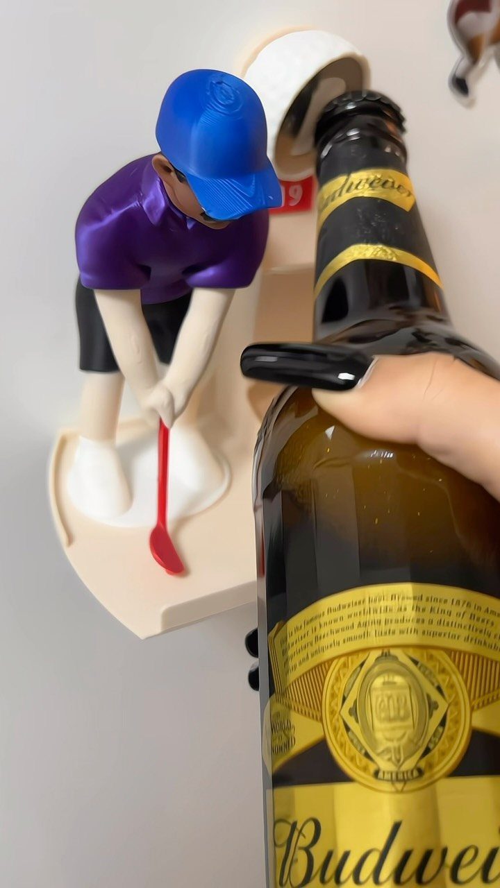 Golfer figurine wall-mounted bottle opener with a Budweiser beer bottle being opened.
