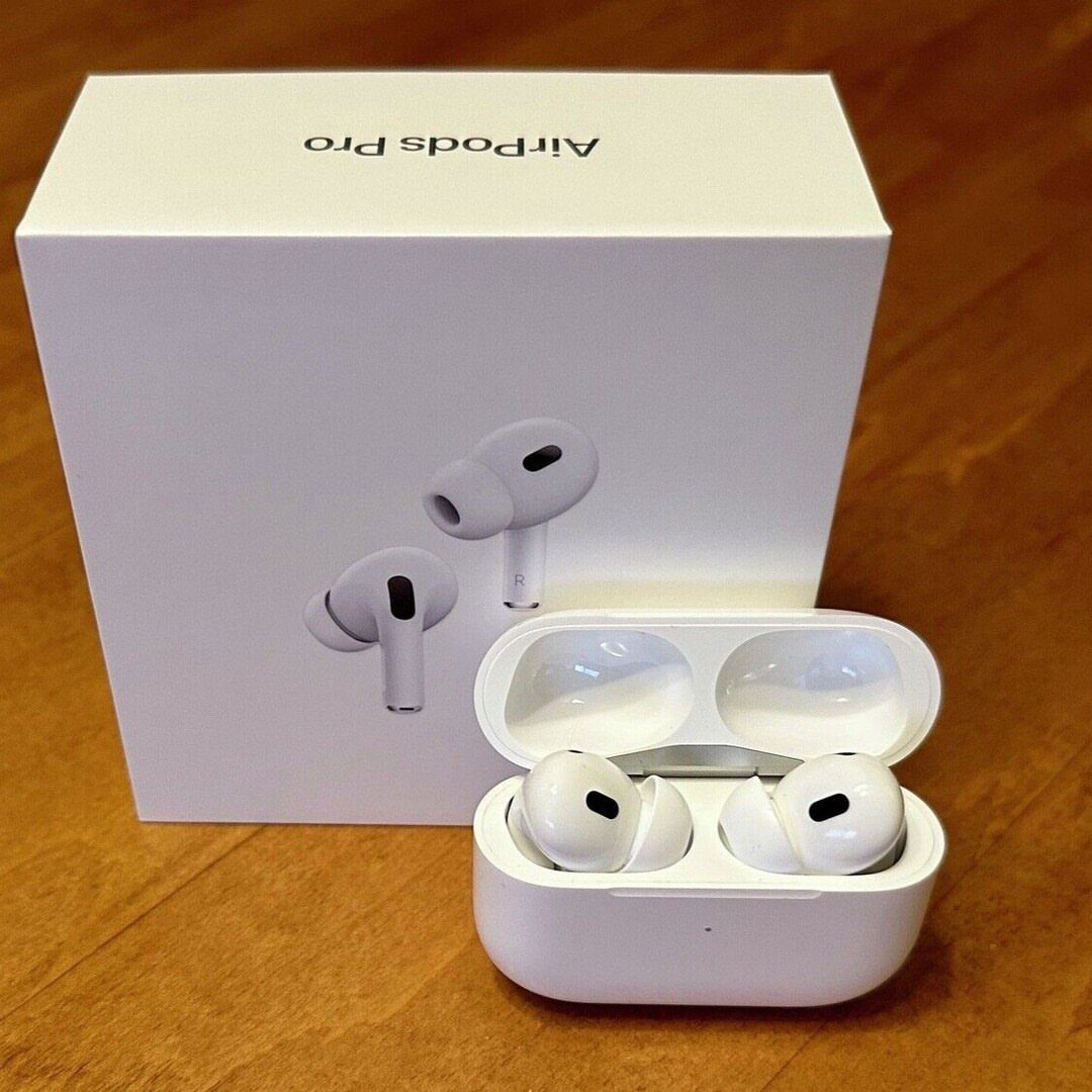 Apple AirPods Pro wireless earbuds and charging case next to their white box.