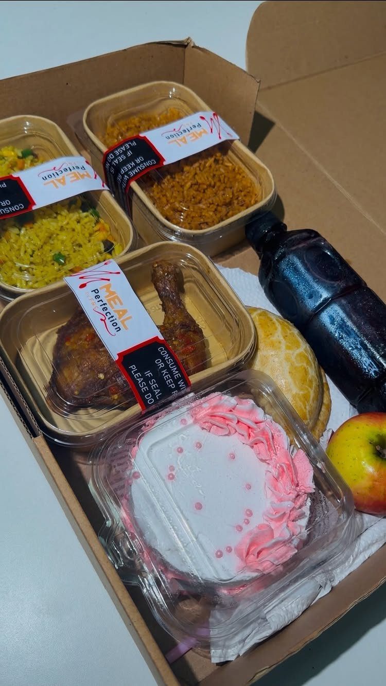 Meal delivery box with rice, roasted chicken, a small cake, and a drink.