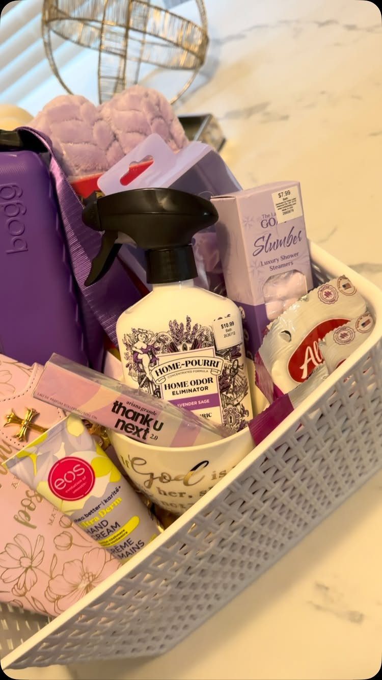 White woven basket filled with purple bath bombs, hand cream, and home spray.