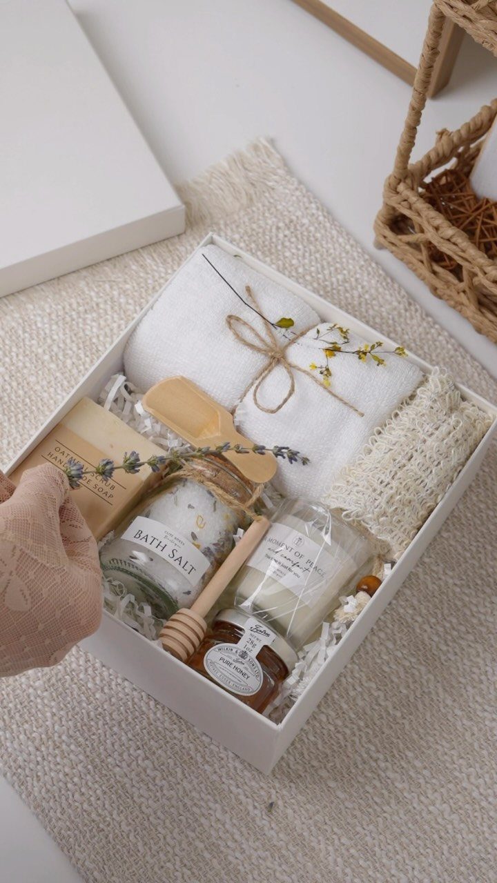Pampering spa gift set in a white box with bath salts and towels.