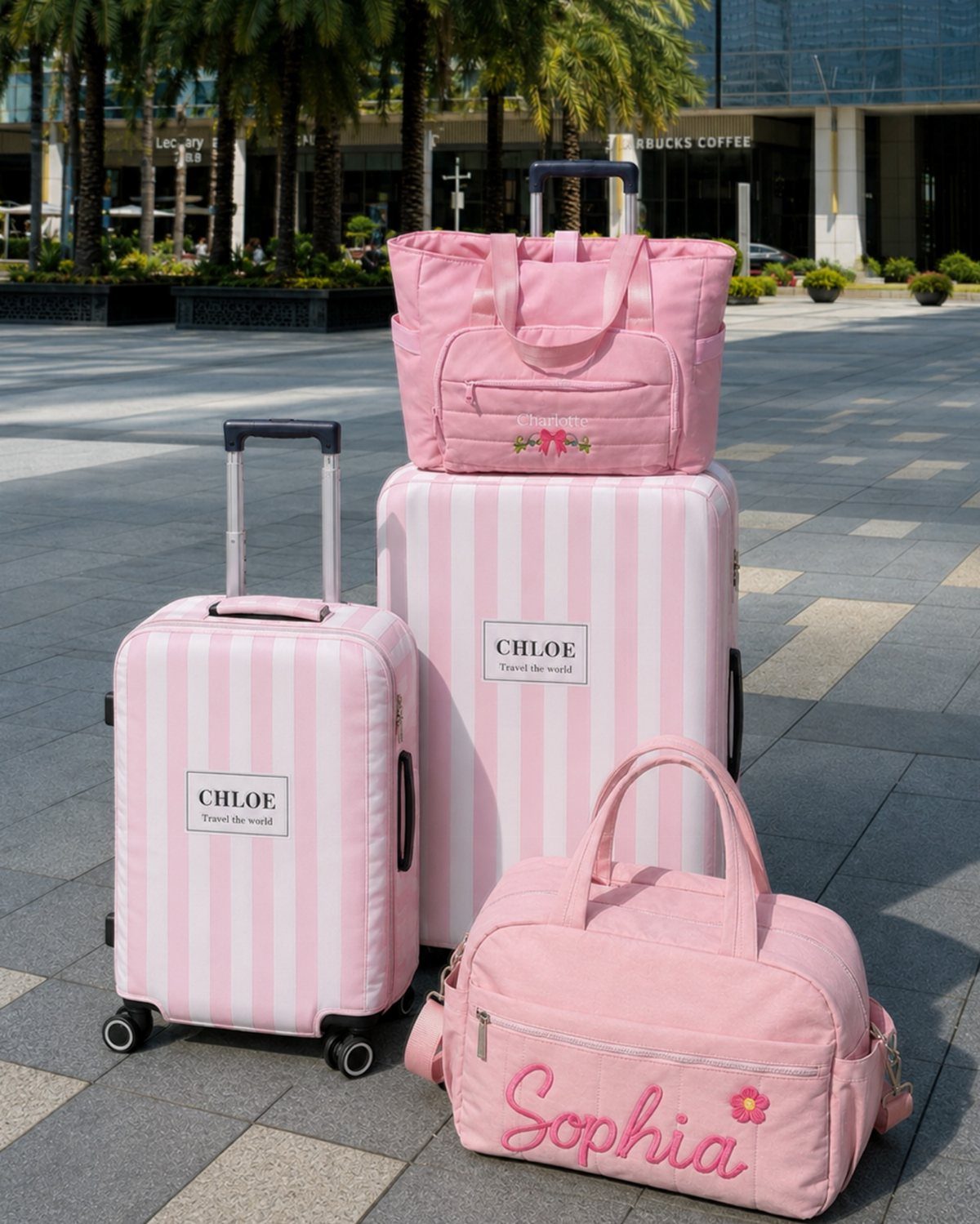 Pink and white striped personalized luggage set including suitcases and travel bags.