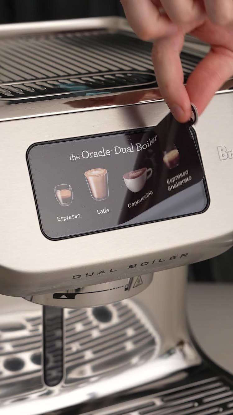 Silver espresso machine with a digital display showing various coffee drink options.