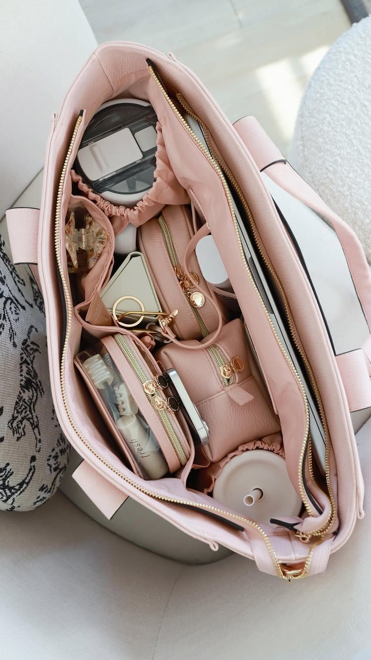 Light pink tote bag filled with organized pouches and daily essentials