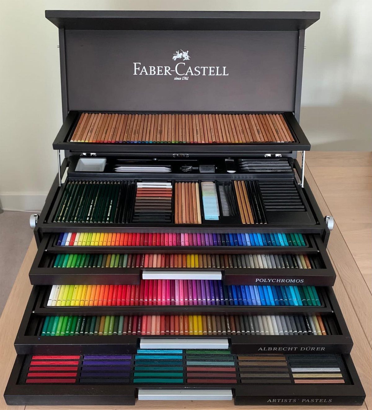 Open Faber-Castell art case filled with a rainbow of professional colored pencils and pastels.