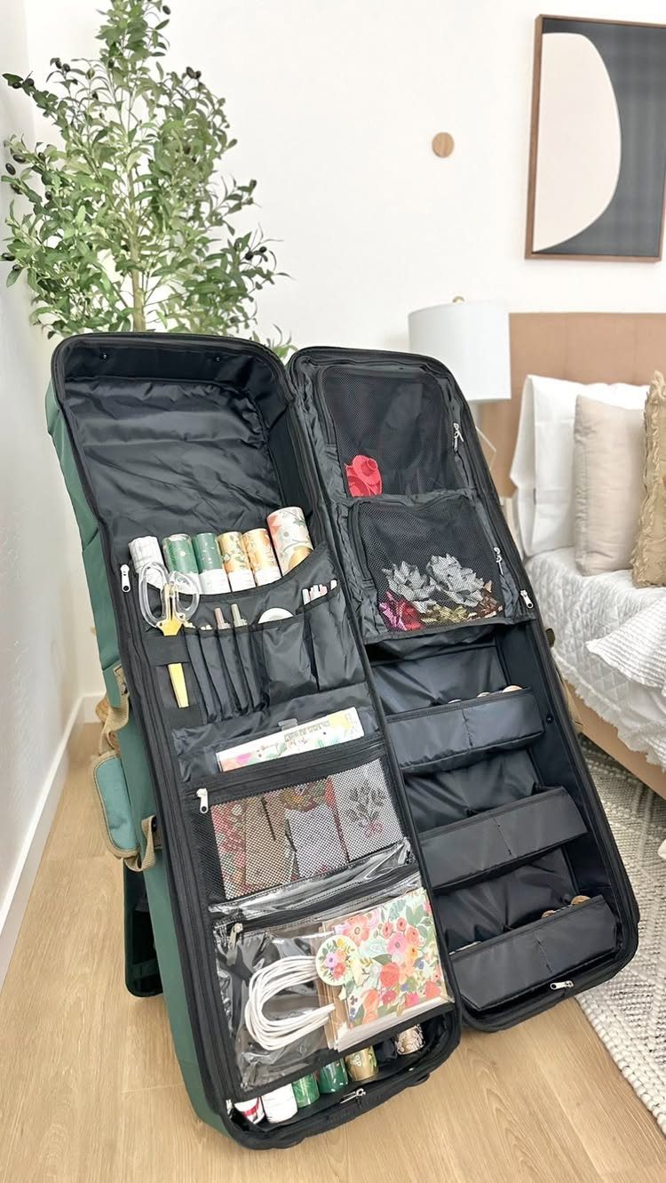 Green art supply organizer bag open and filled with paints and brushes.