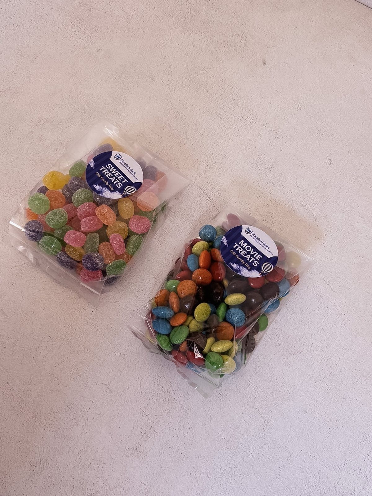 Two bags of colorful candies with labels for sweet and movie treats.