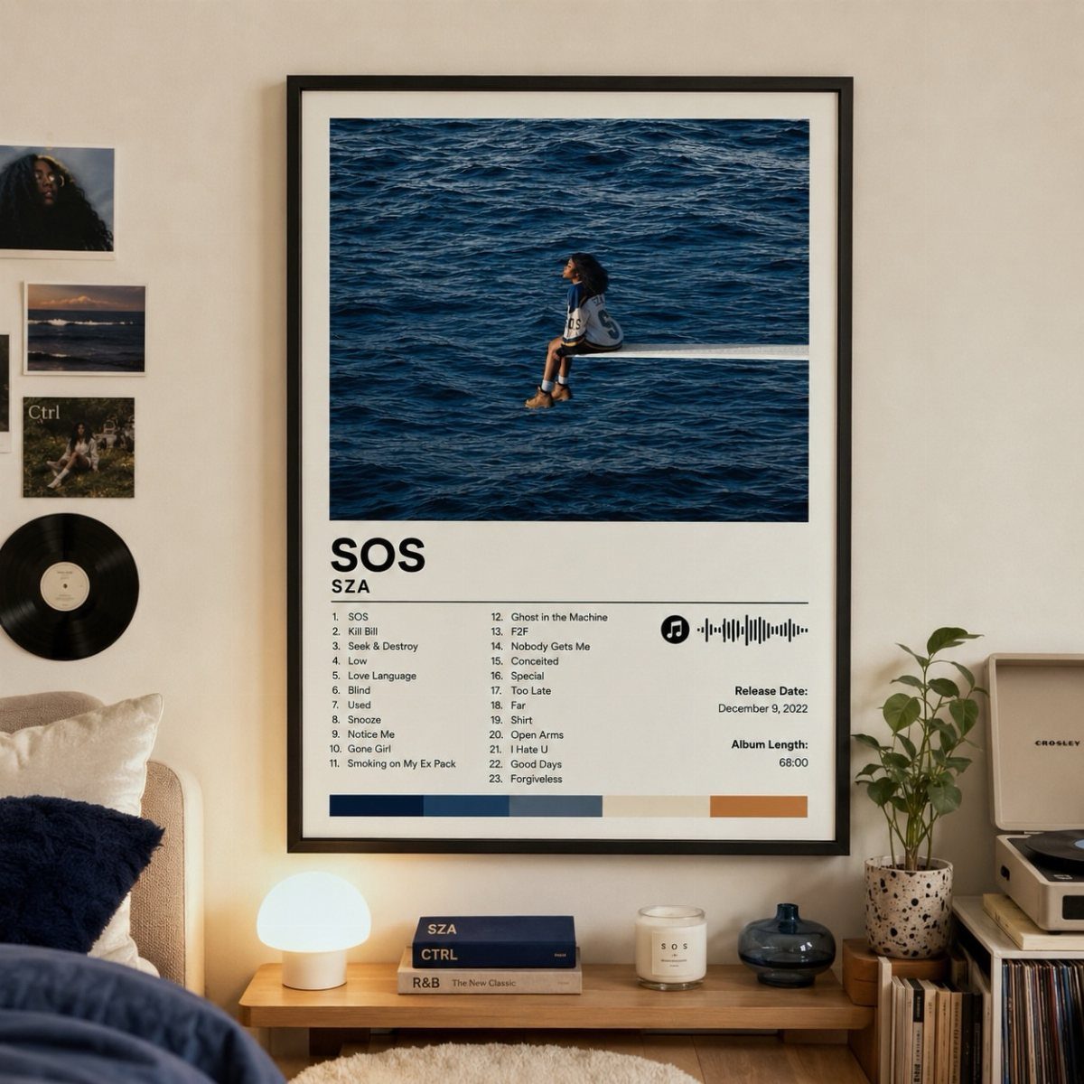 Framed minimalist SZA SOS album art poster hanging on a bedroom wall