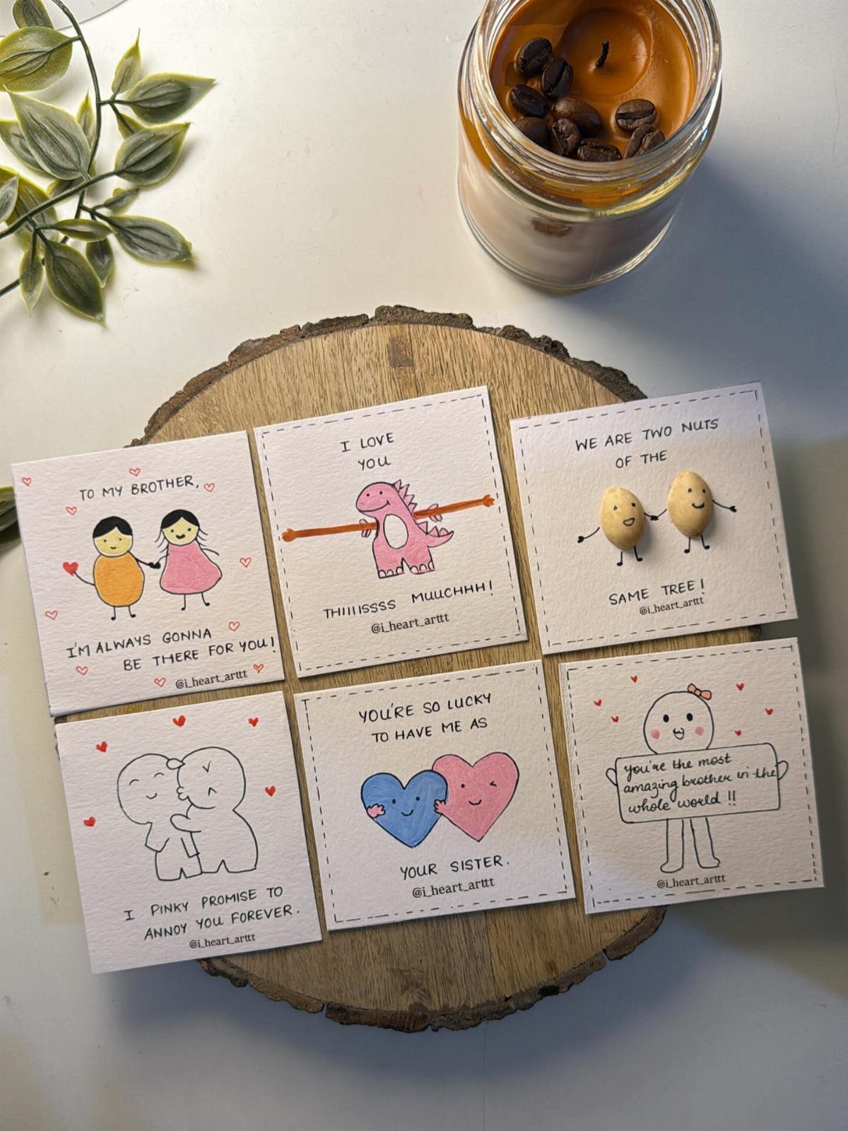 Handwritten cards with cute illustrations for siblings resting on a wooden slice.