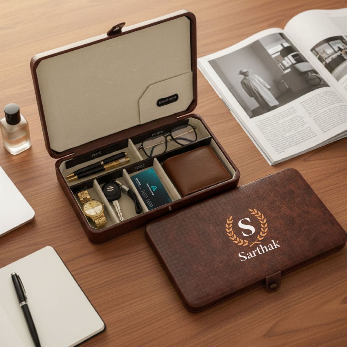 Brown leather organizer box with watch, wallet, and pen on wooden table
