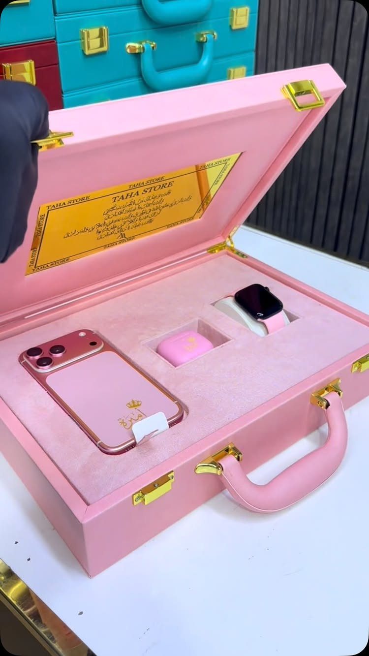 Pink gift set with smartphone, smartwatch, and earbuds in a pink suitcase box