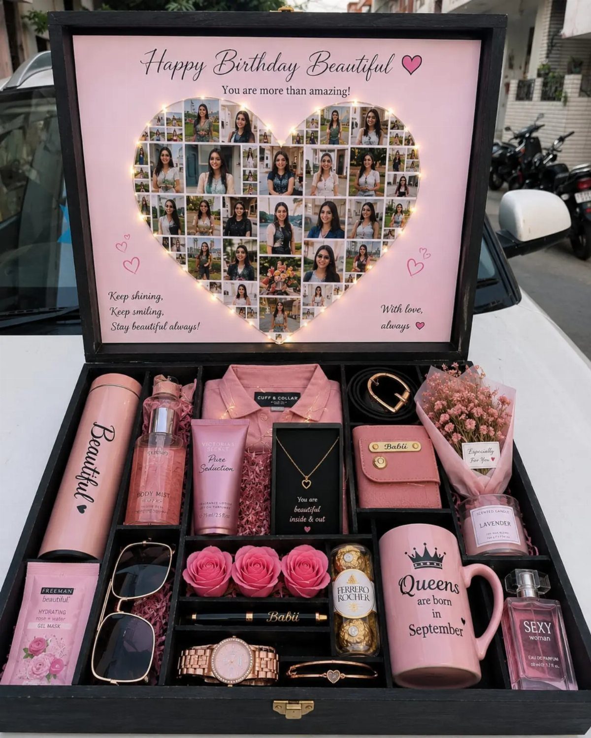 Pink themed gift box for a woman containing jewelry, cosmetics, and a photo collage.