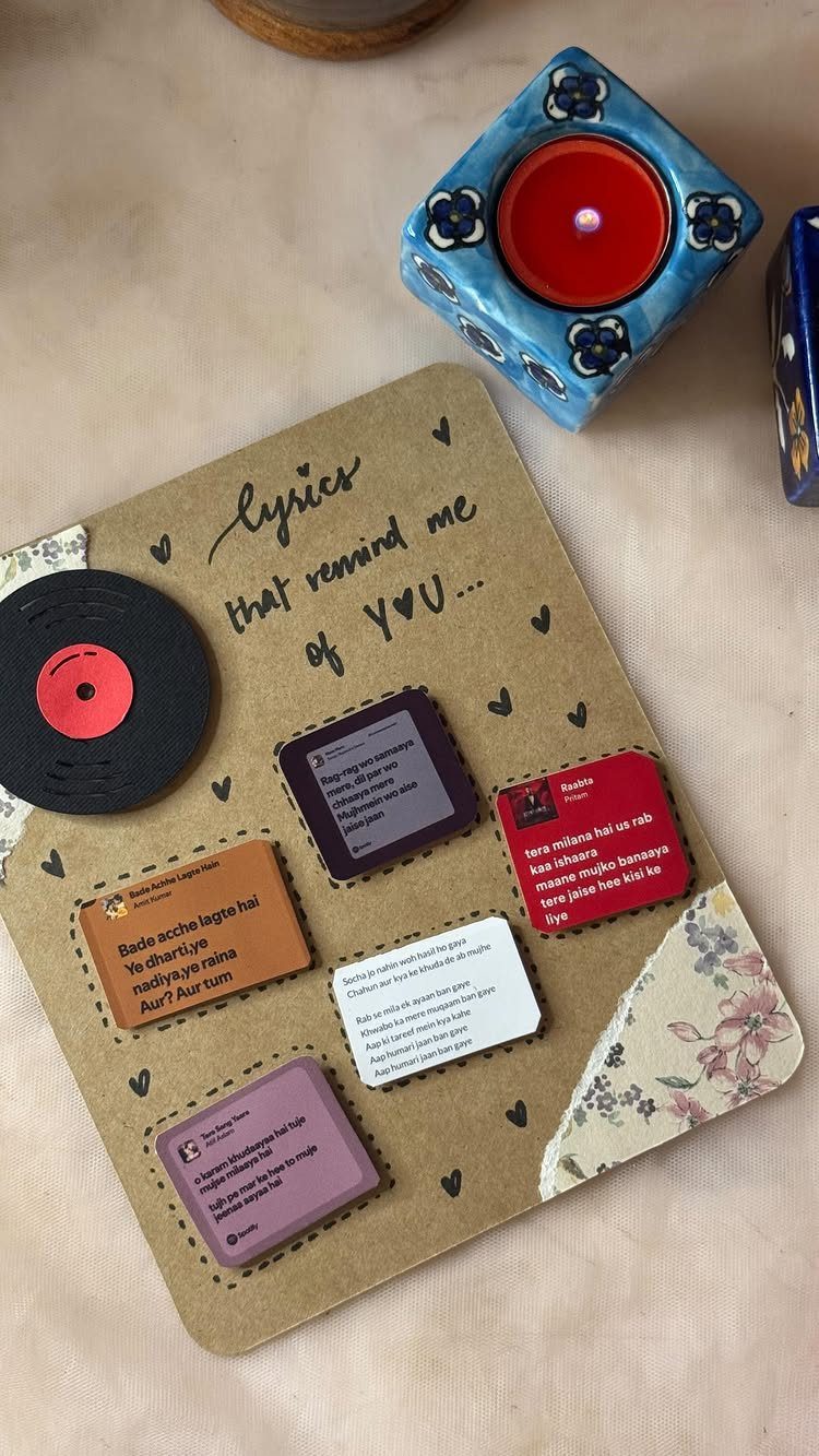 Handmade scrapbook page with a vinyl record and cards featuring song lyrics.