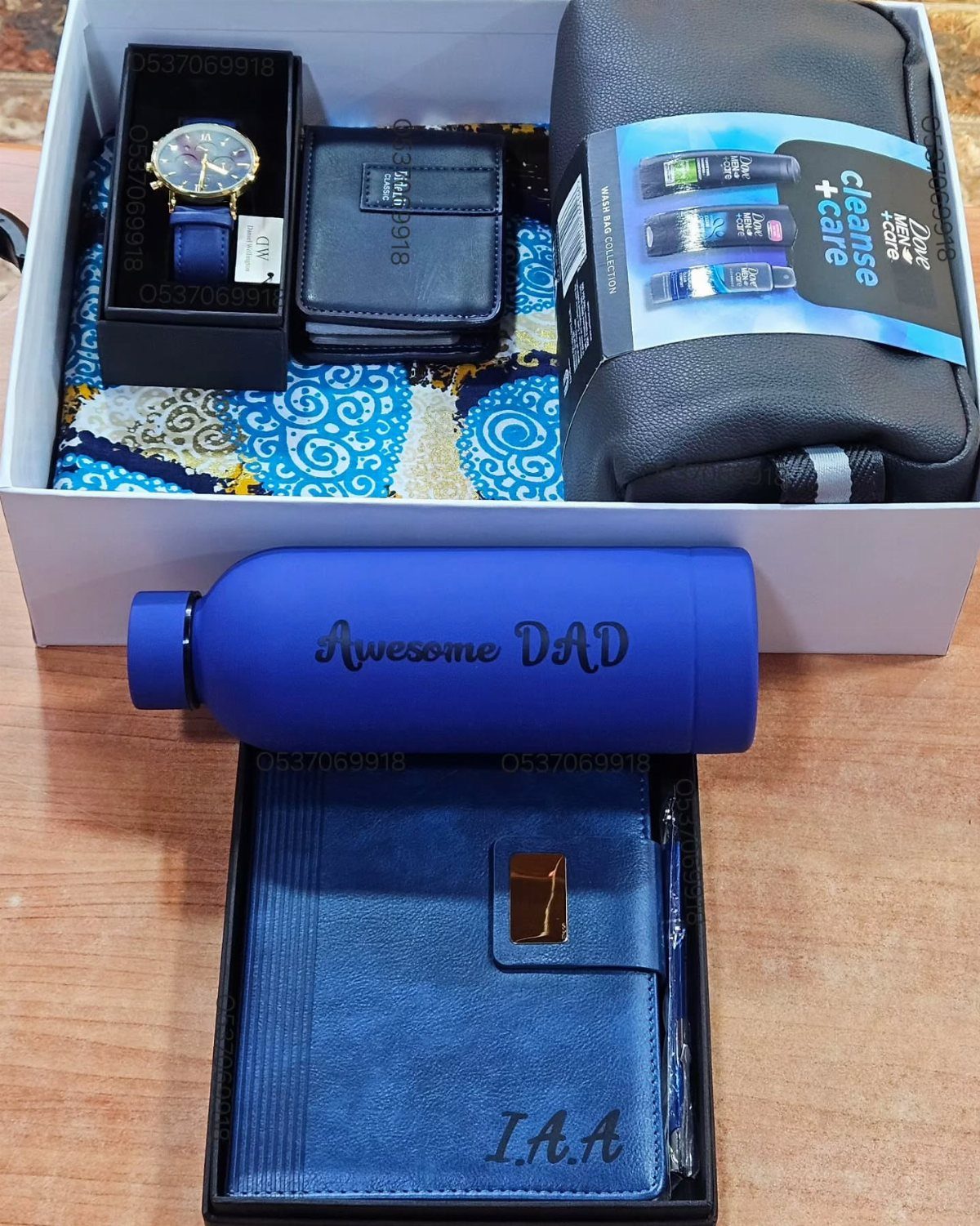 Gift set for dad featuring a blue water bottle, notebook, watch, and wallet.
