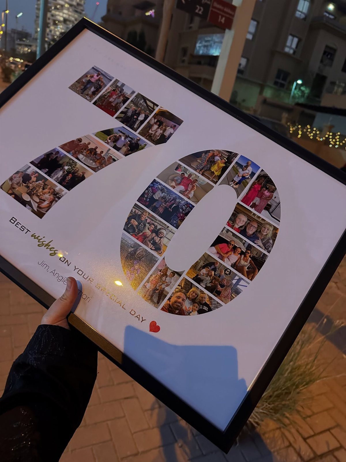 Framed photo collage of family pictures arranged in the shape of number 70.