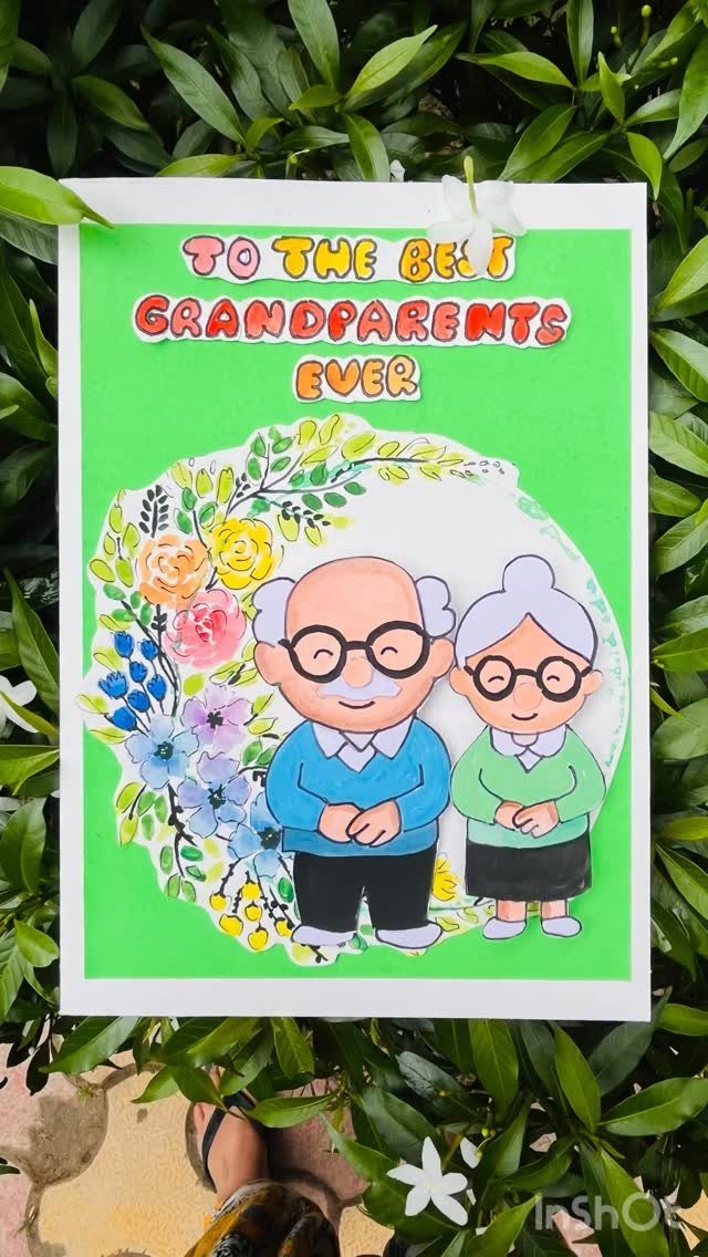 Handmade greeting card for grandparents with cartoon couple and colorful floral border.