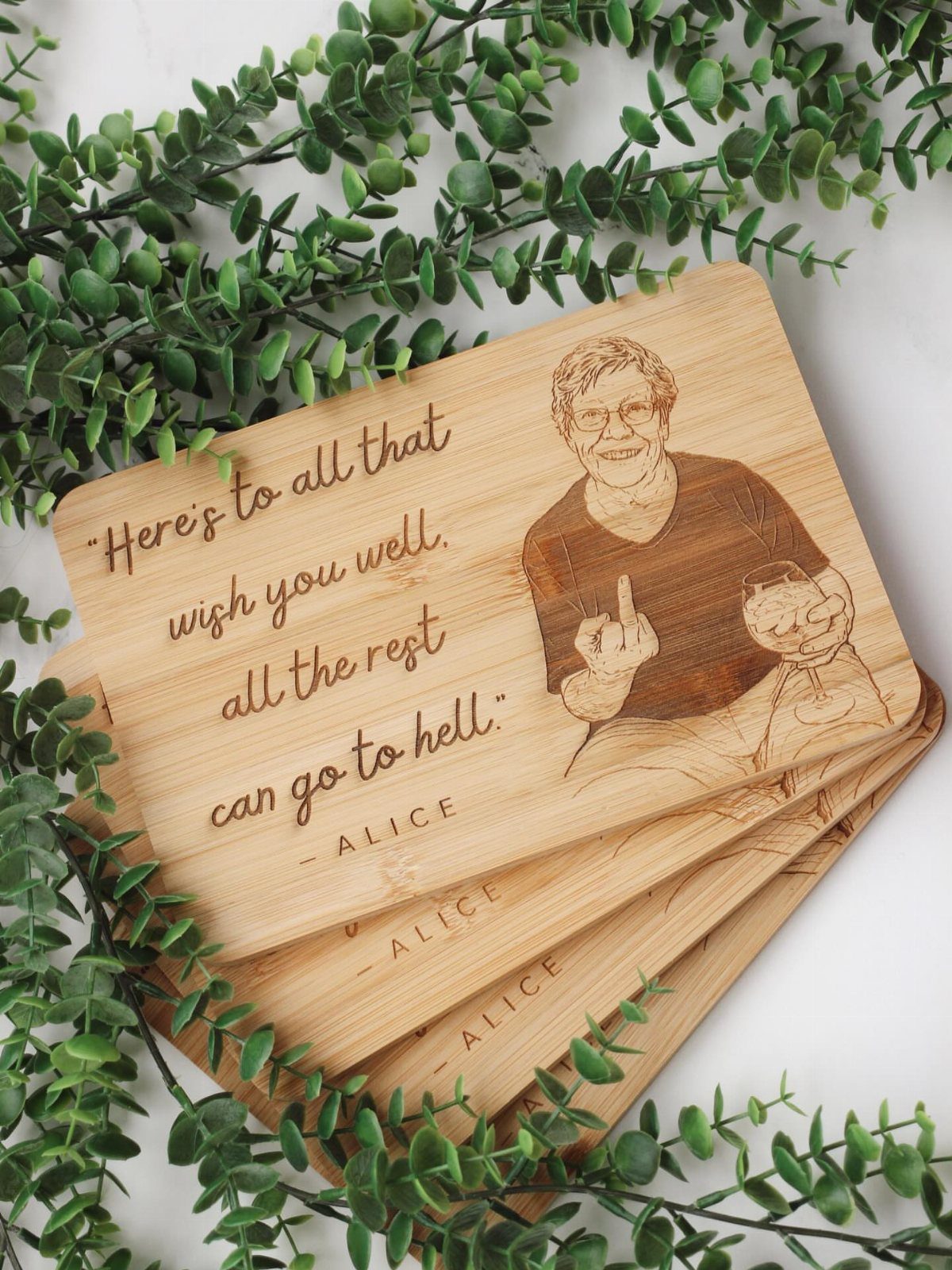 Engraved wooden boards with a portrait of an older woman and a quote.