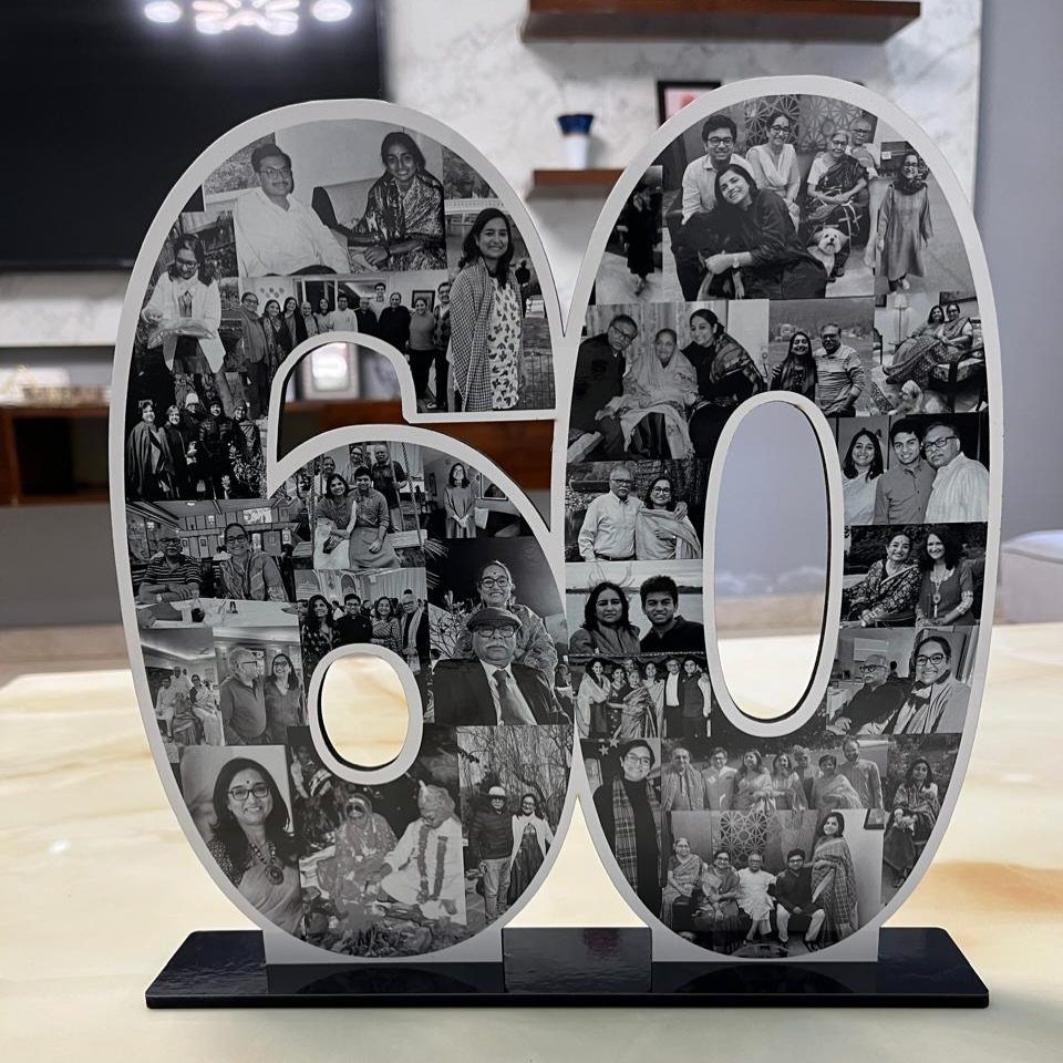 Number 60 cutout filled with black and white family photos on black base