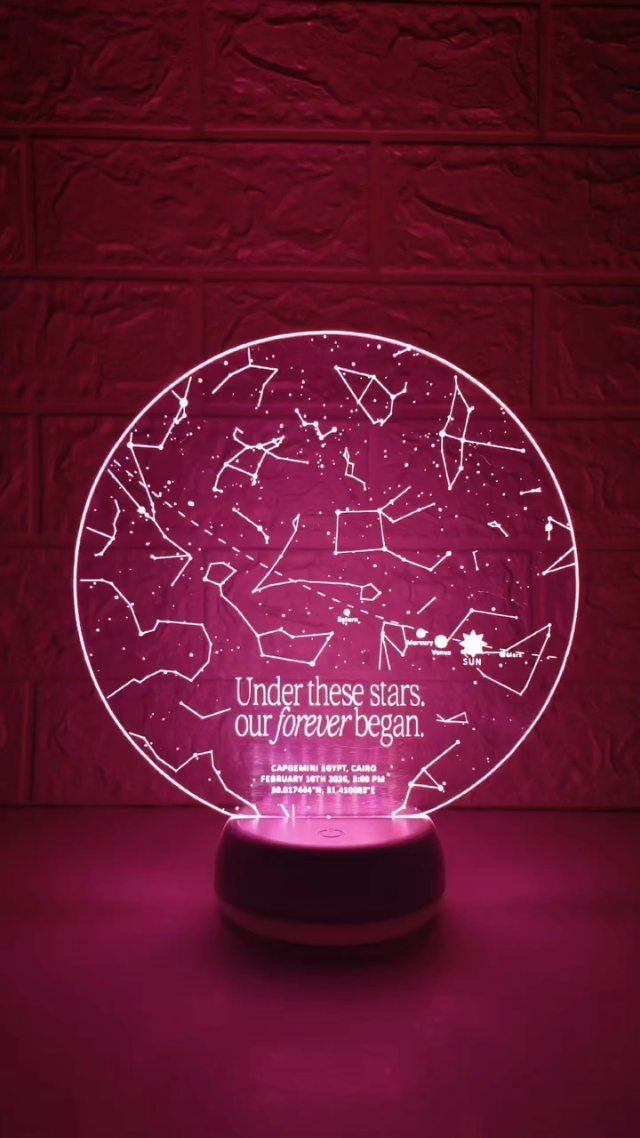 Glowing pink circular star map lamp with constellations and romantic text on base