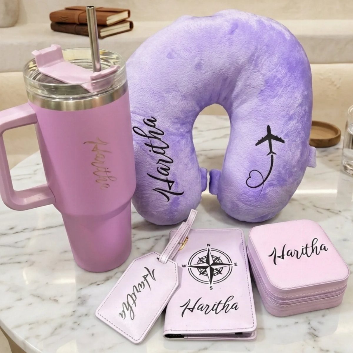 Purple personalized travel set with tumbler, neck pillow, passport holder, and luggage tag.