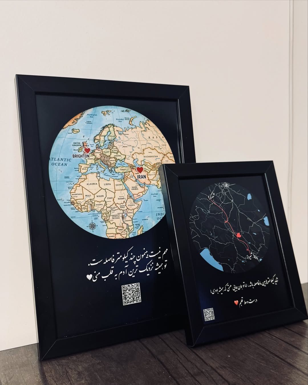 Two framed circular maps with red heart markers and white calligraphy on black backgrounds.