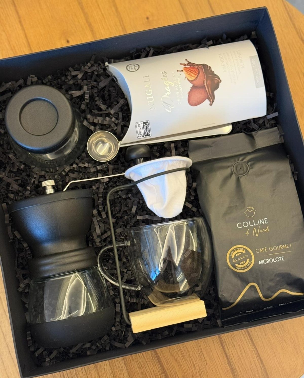 Coffee gift set with grinder, pour-over carafe, and beans in a blue box.