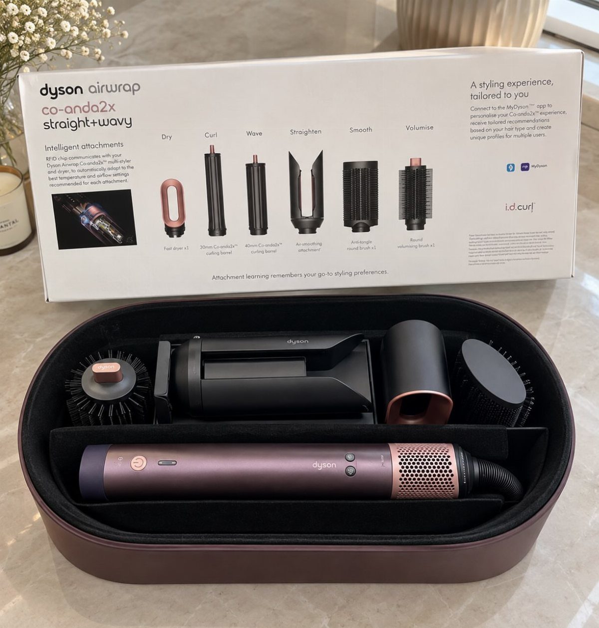 Dyson Airwrap hair styler with attachments in a case and product box.