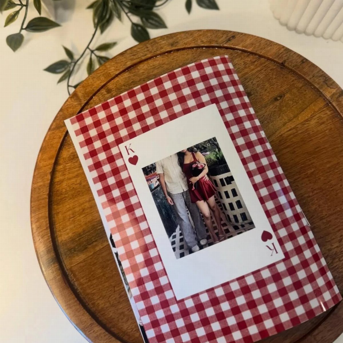 Handmade gingham card with a couple's polaroid photo on a wooden tray