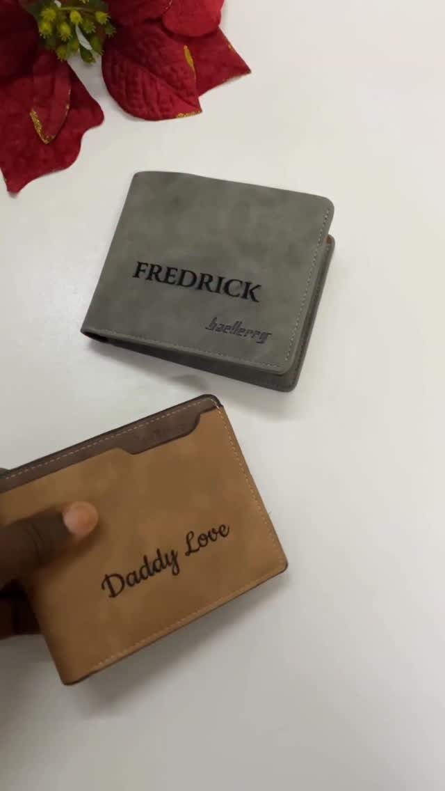 Two personalized wallets, one grey and one tan, with custom engraved text.